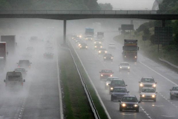 WESTON-SUPER-MARE, UNITED KINGDOM - JULY 09:  Traffic drives through rain and spray on the M5 motorway on July 9 2008 near Weston-Super-Mare, England. Weather forecasts have suggested that the UK is in for more wet and unsettled weather.  (Photo by Matt Cardy/Getty Images)